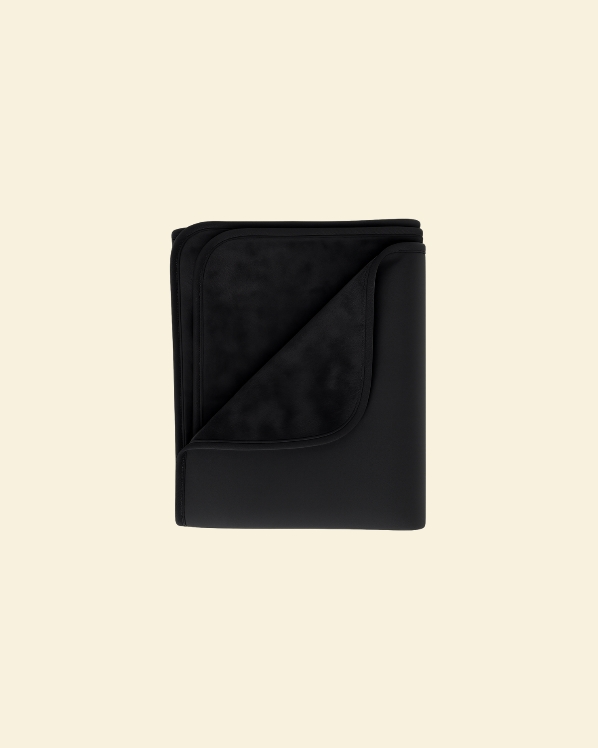 Black waterproof splash blanket folded on a beige background