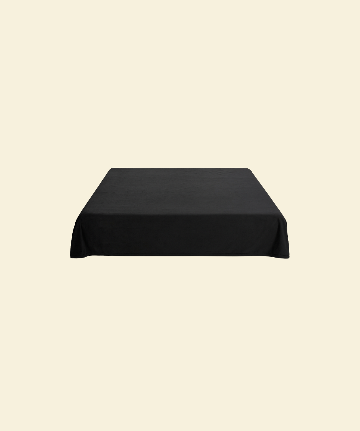 Black waterproof splash blanket laid over a bed 