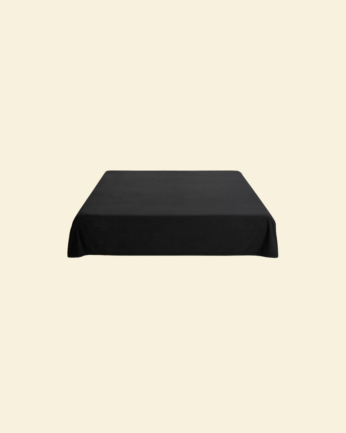Black waterproof splash blanket laid over a bed 