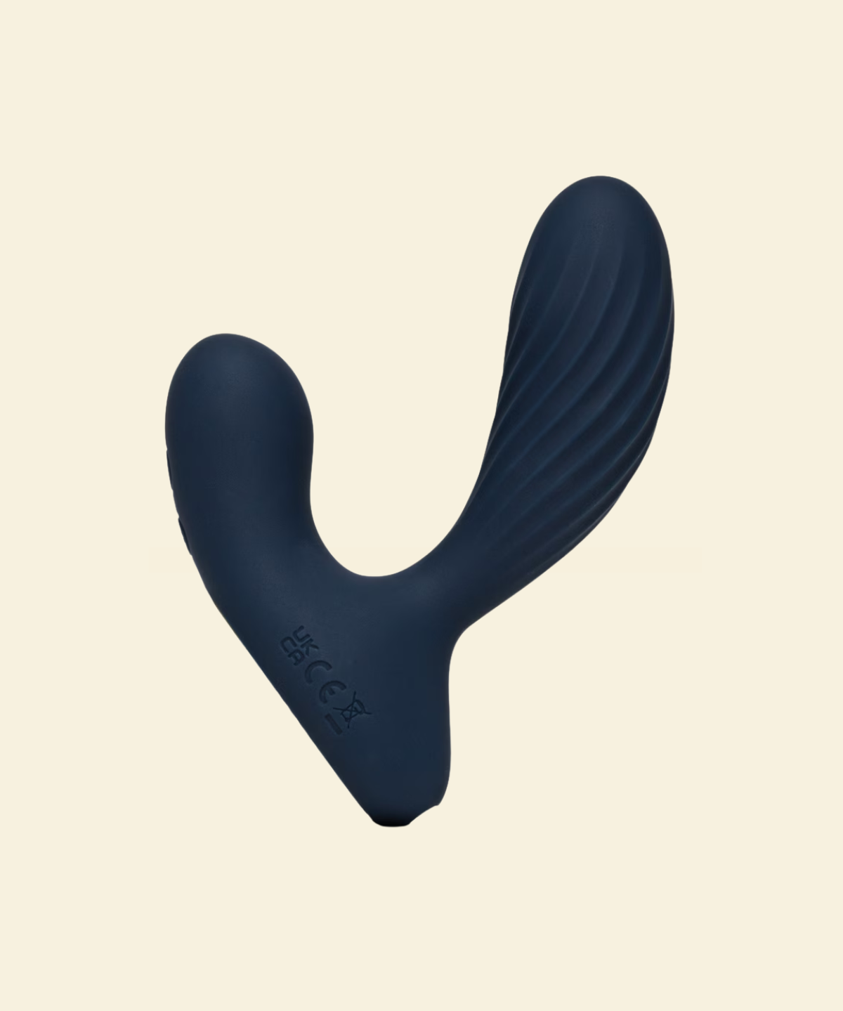 Navy blue prostate massager on beige background