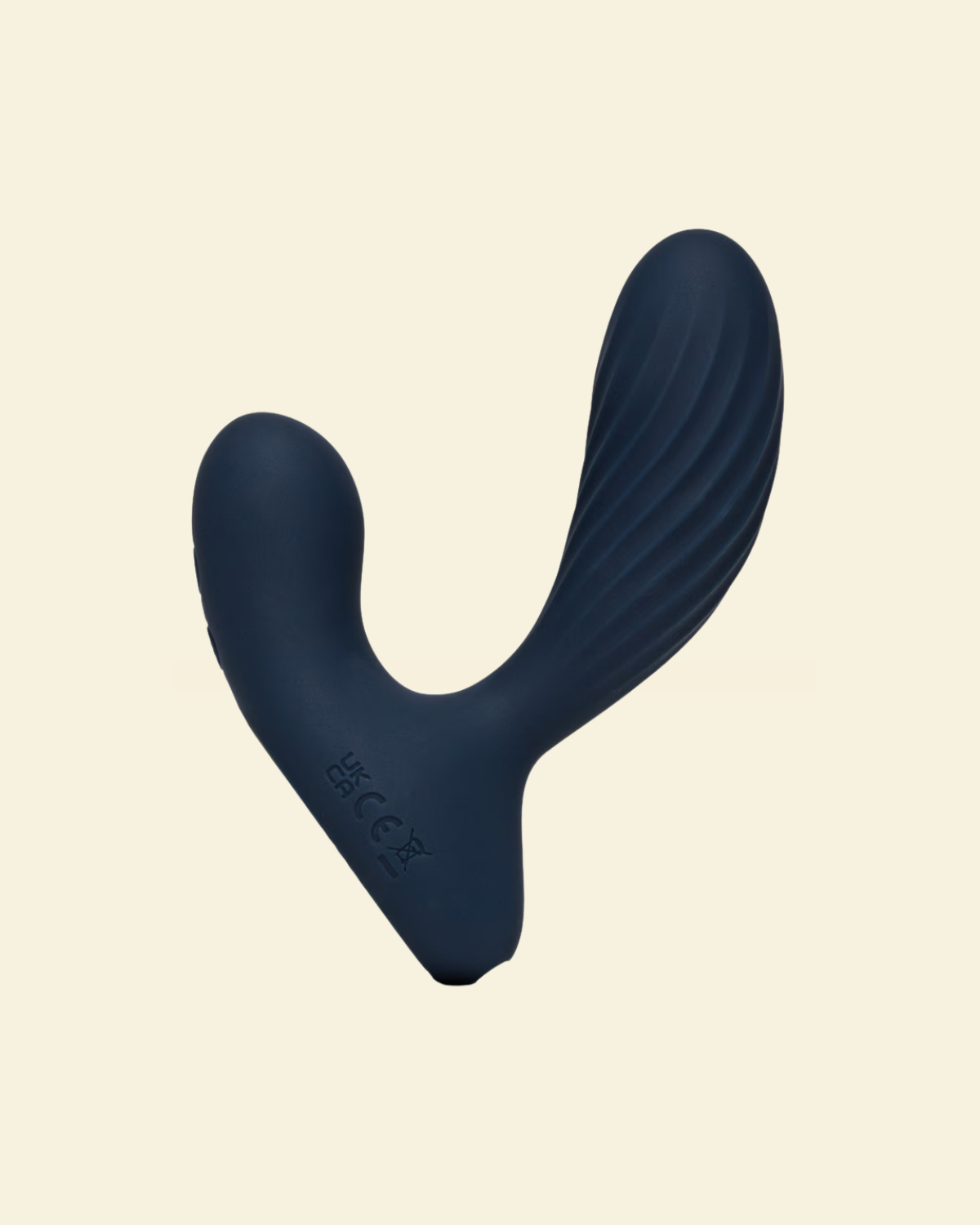 Navy blue prostate massager on beige background