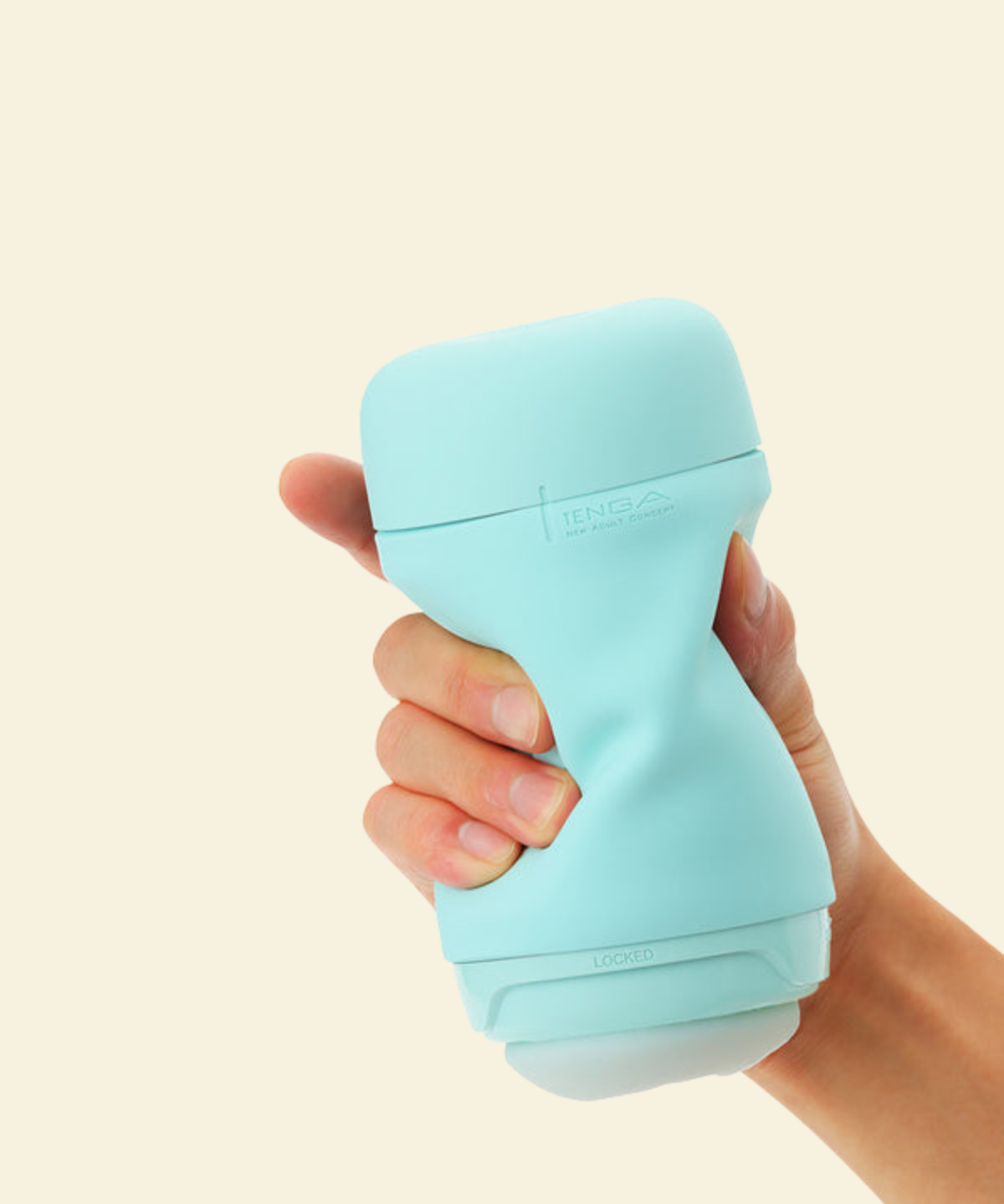 A hand holding a mint green reusable stroker 
