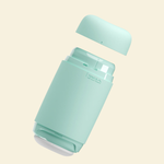 A mint green reusable and soft masturbator on a beige background
