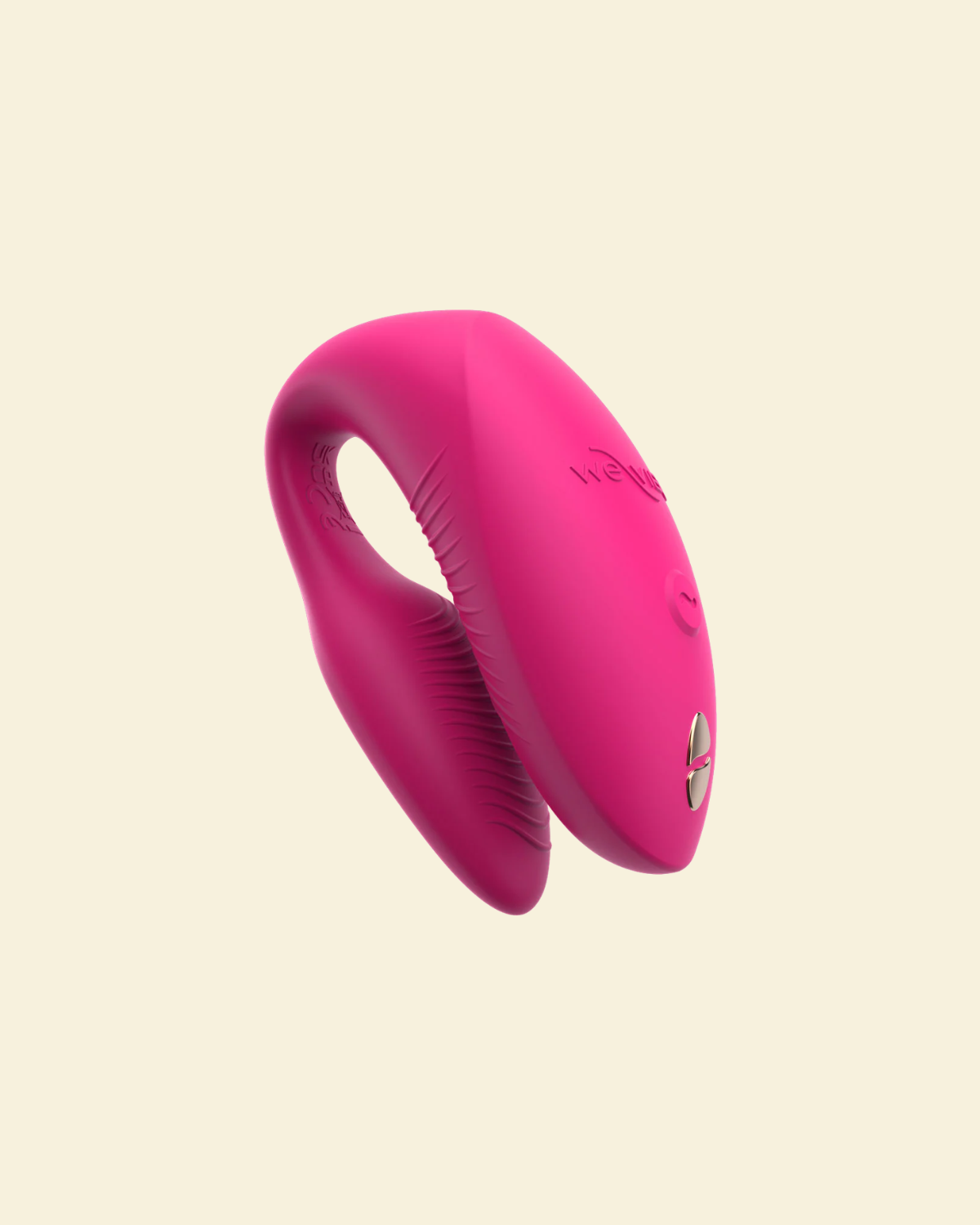 Pink silicone vibrator on beige background