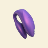 Purple wearable vibrator on beige background