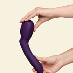 Purple silicone wand vibrator being held by 2 hands 