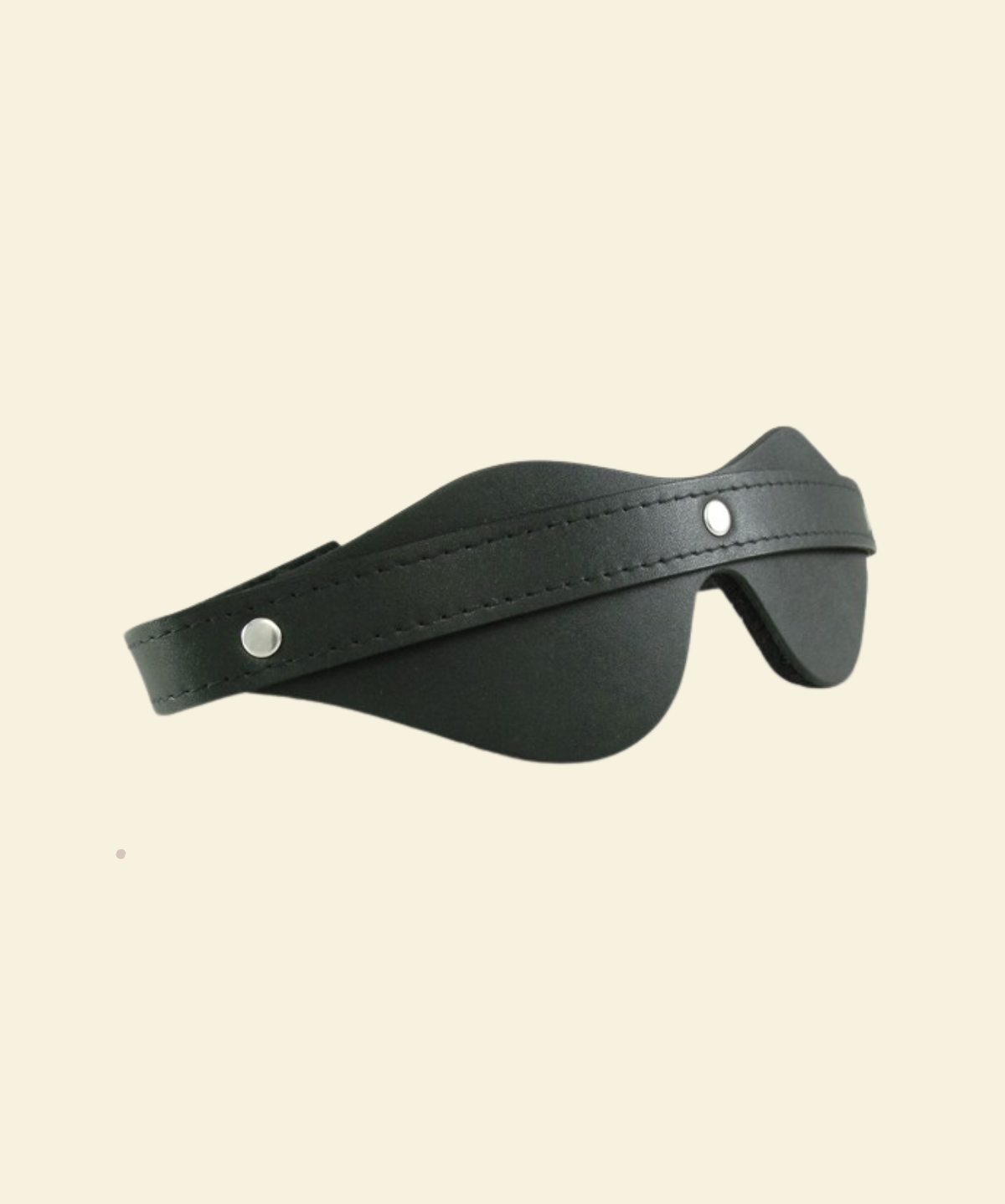 Black leather blindfold on beige background