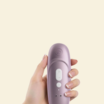 Hand holding the Womanizer Pro showcasing the back and controls