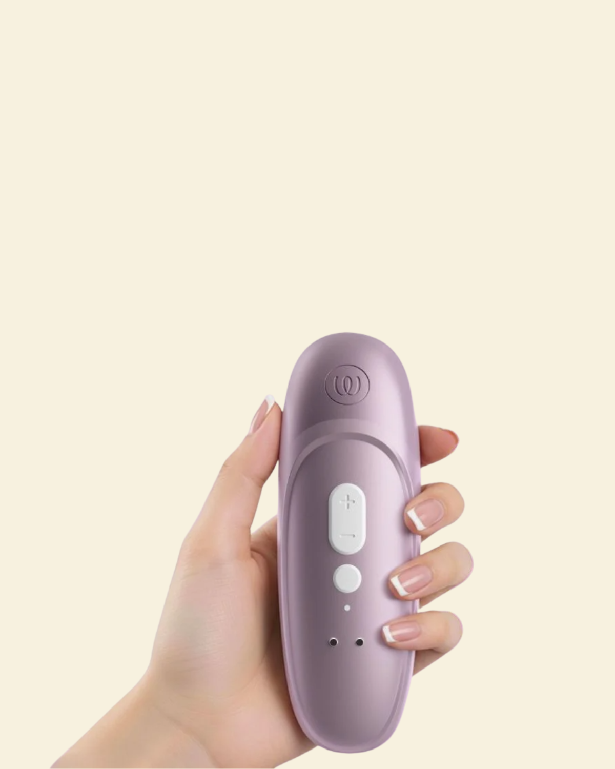 Hand holding the Womanizer Pro showcasing the back and controls