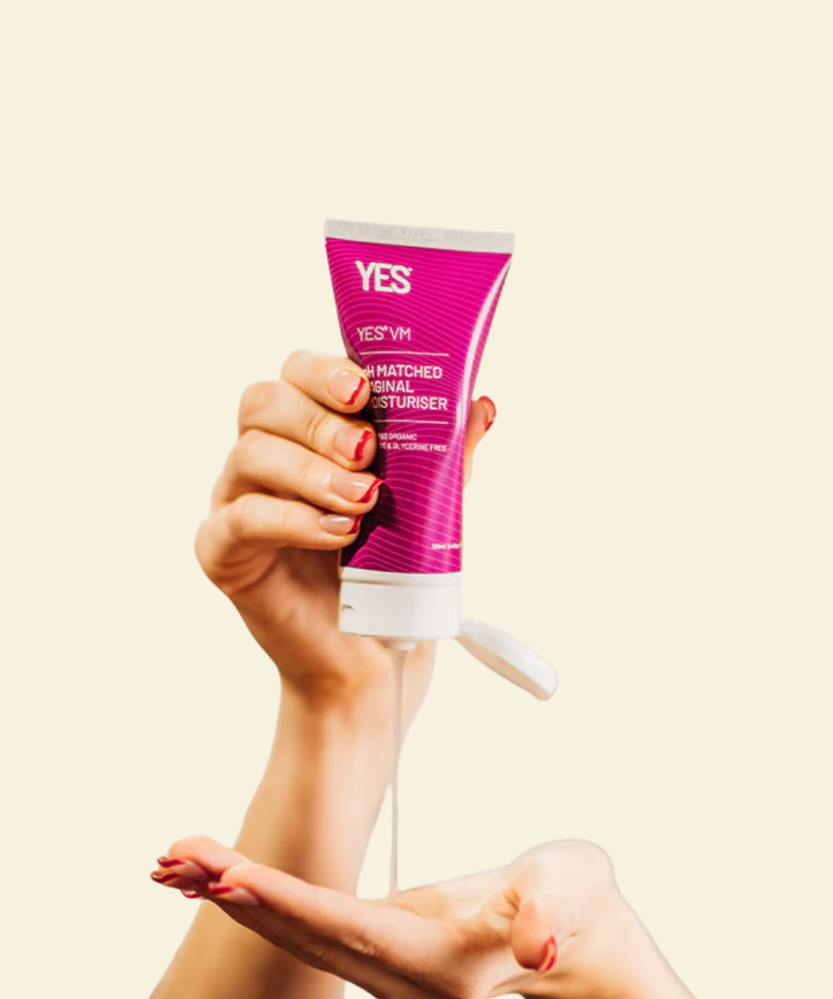 Hand holding a tube of 'YES VM' moisturizer against a beige background